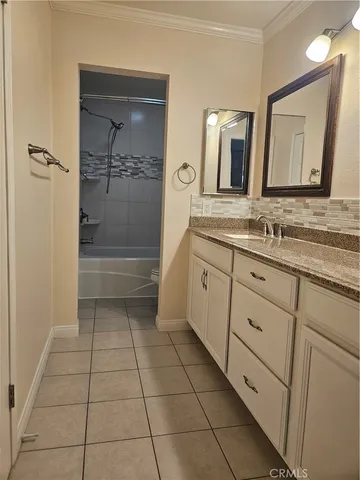 a bathroom with a double vanity sink and mirror