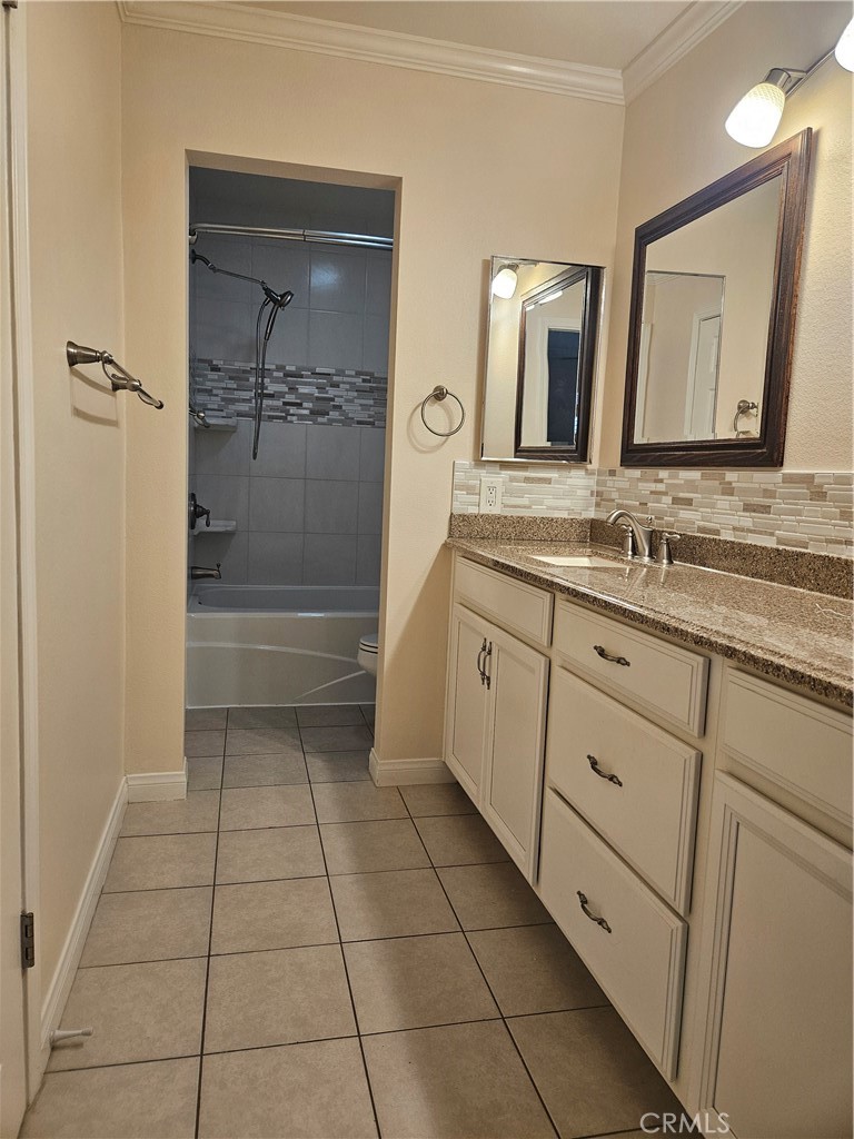 8933 Biscayne Court, Unit 221H Huntington Beach, CA 92646 - Photo 10 of 13 a bathroom with a double vanity sink and mirror