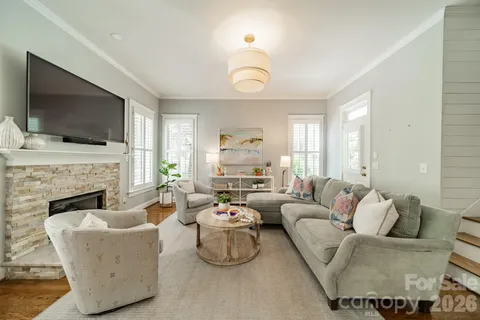 a living room with furniture fireplace and flat screen tv
