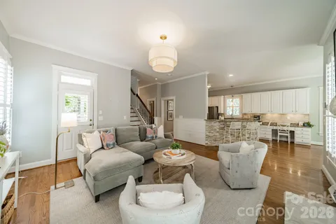 a living room with furniture a rug and a window