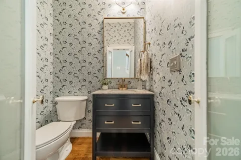 a bathroom with a toilet and a shower curtain
