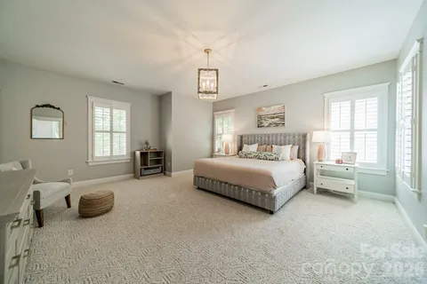a spacious bedroom with a bed and a couch