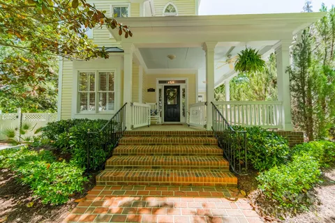 a front view of a house with a garden