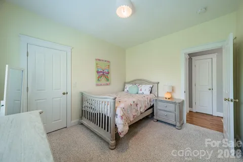 a bedroom with a bed and a baby crib