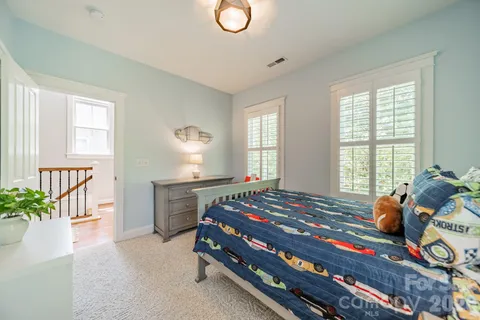 a bedroom with bed and window