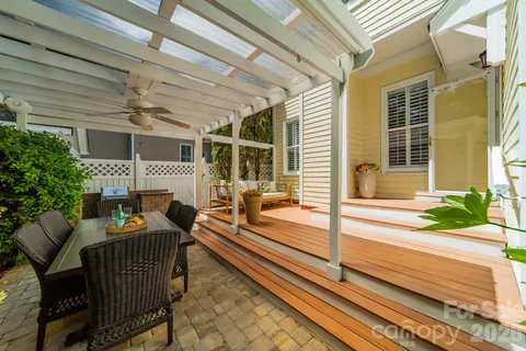 a porch with a bench next to a yard
