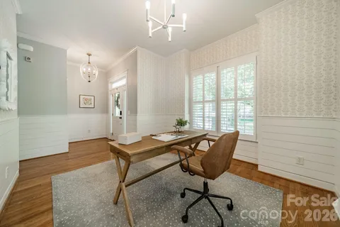 a view of a workspace with furniture and a window
