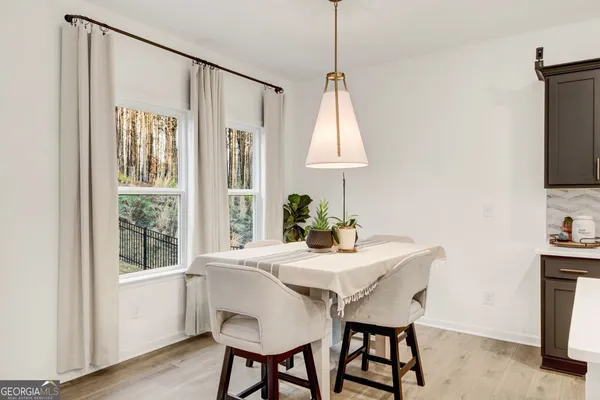 a dining room with furniture and window
