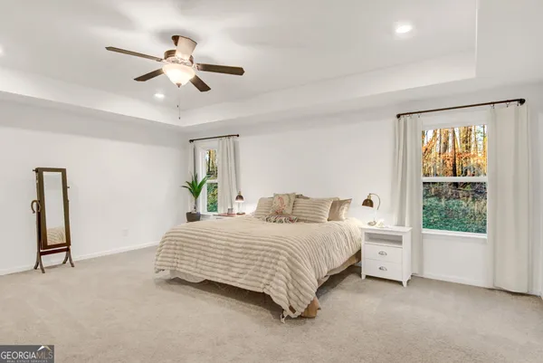 a bedroom with a large bed and a chandelier