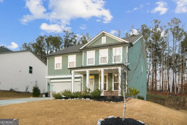 a front view of a house with a yard