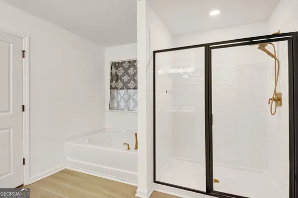 a bathroom with a bathtub and a shower