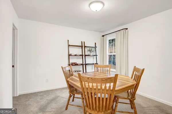 a view of a dining room with furniture and window
