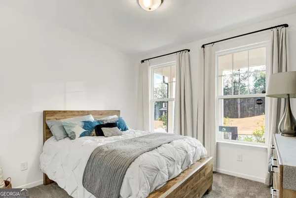 a bedroom with a large bed and a window