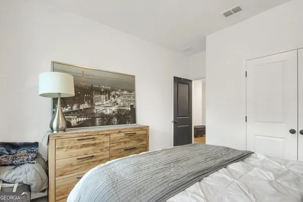 a bedroom with a bed and a dresser