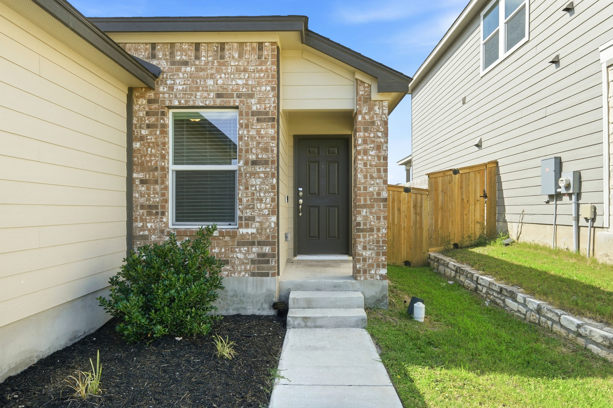 220 Lucky Texan Road Jarrell, TX 76537 - Photo 3 of 19 A welcoming brick and siding facade with a neat pathway invites you to this charming residence.