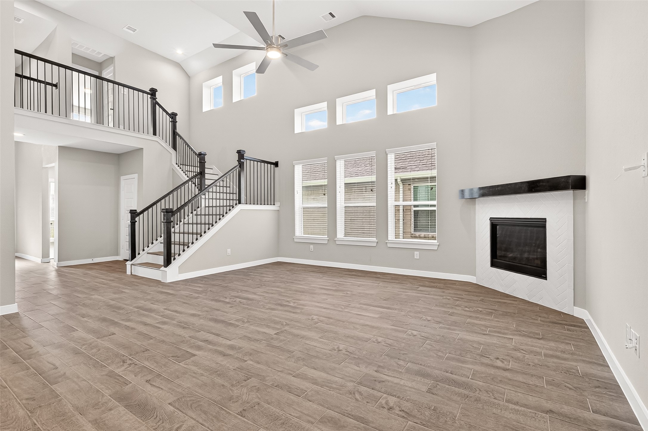 2142 Reed Cave Lane Spring, TX 77386 - Photo 12 of 50 a view of an empty room with wooden floor fireplace and a window