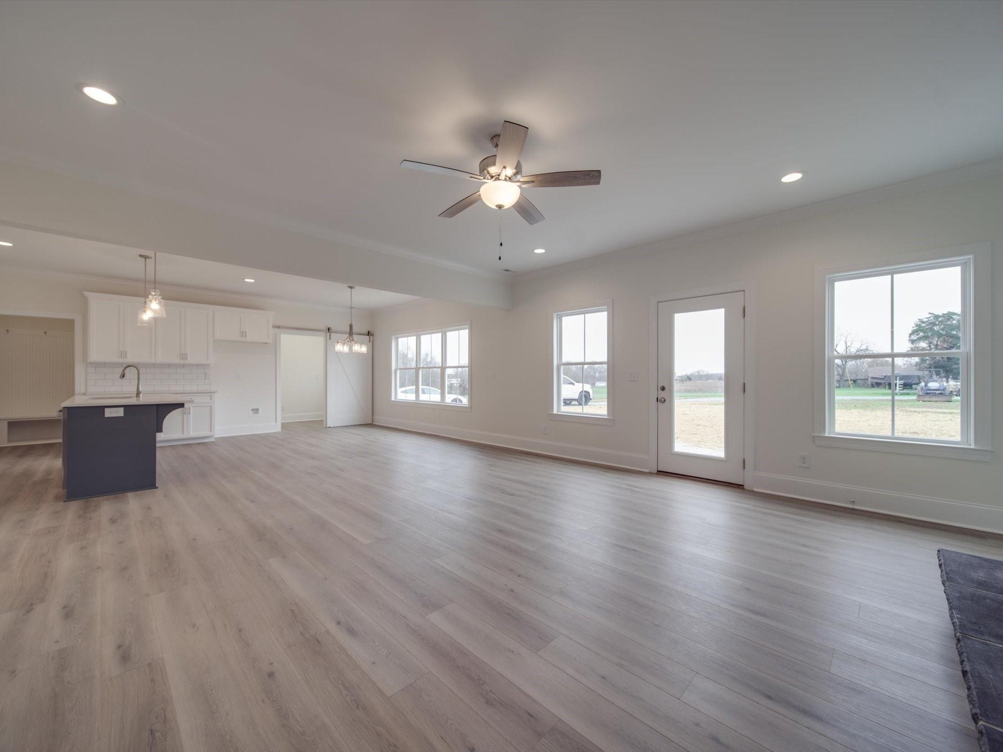 3815 East Brief Road Monroe, NC 28110 - Photo 16 of 46 a view of an empty room with a window and wooden floor