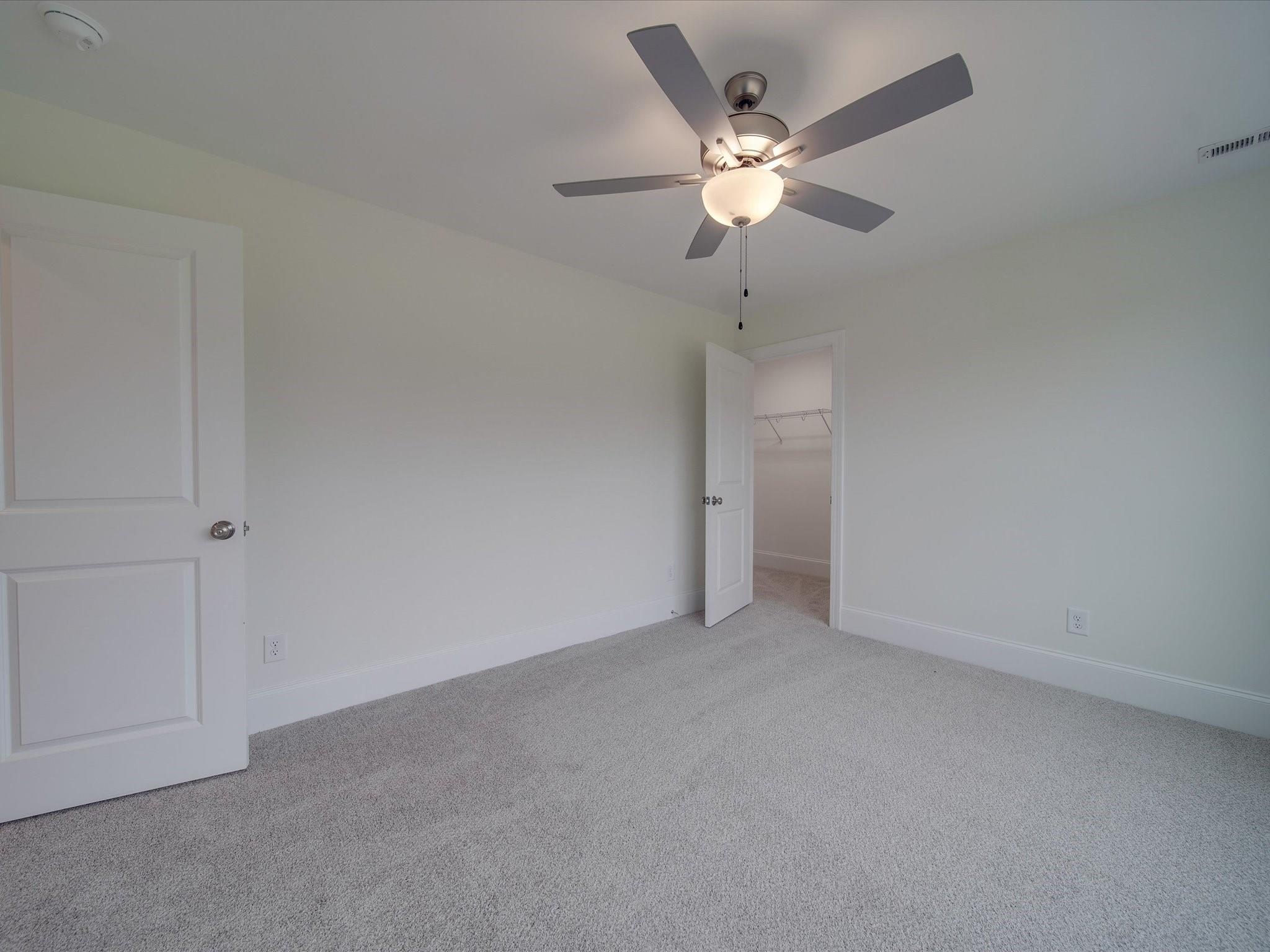 3815 East Brief Road Monroe, NC 28110 - Photo 21 of 46 an empty room with closet and a chandelier fan