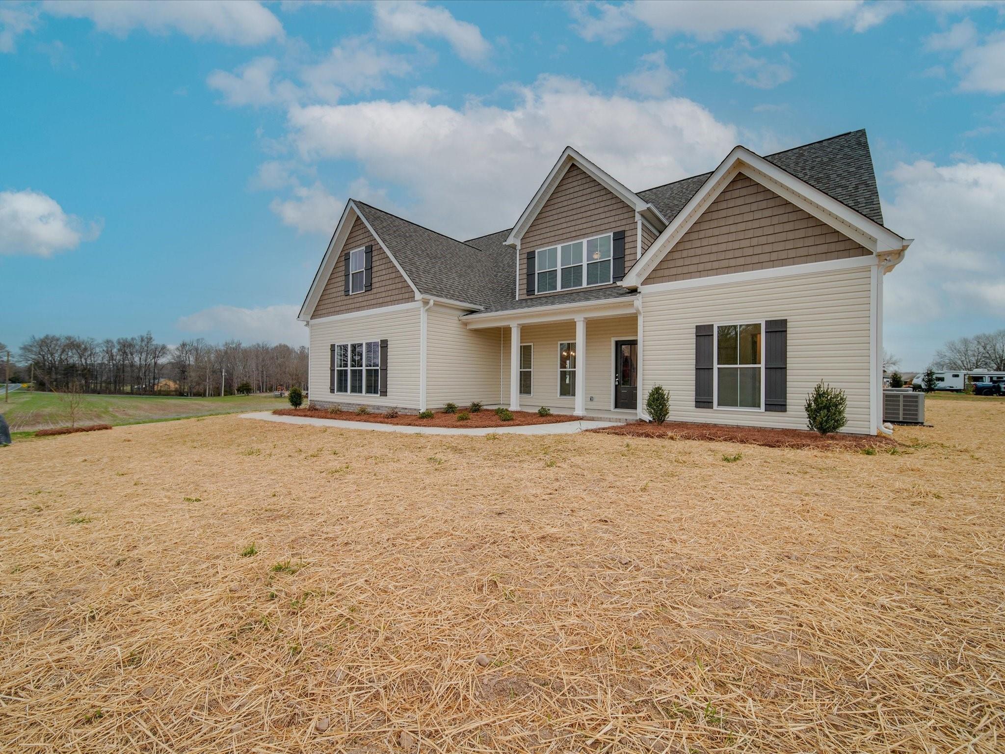 3815 East Brief Road Monroe, NC 28110 - Photo 4 of 46 a front view of house with yard and lake view in back