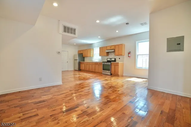 a view of kitchen with cabinets and wooden floor