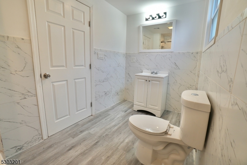 131 Sylvan Avenue Newark, NJ 07104 - Photo 8 of 9 a bathroom with a toilet a sink and bathtub
