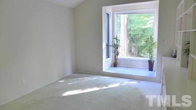 247 Fox Ridge Road Pittsboro, NC 27312 - Photo 15 of 24 Secondary bedrooms are large and light-filled. Bedroom 2 features a wall of built ins, plus a lovely tiled alcove for plants, with gorgeous picture window above.