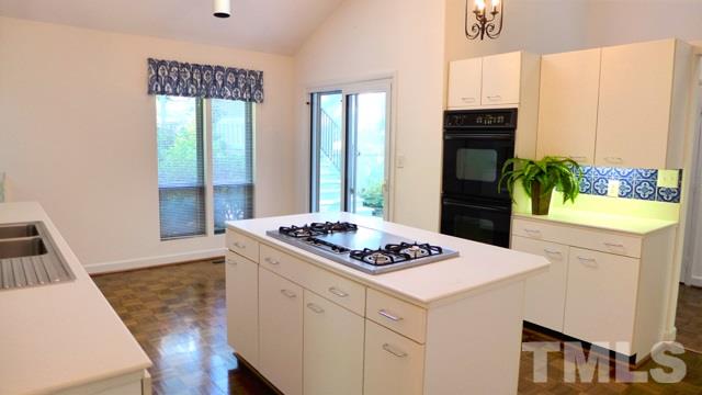 247 Fox Ridge Road Pittsboro, NC 27312 - Photo 8 of 24 The amply-sided Kitchen is sure to please! Abundant cabinet and counter space, solid surface counters, and center island with gas cooktop.