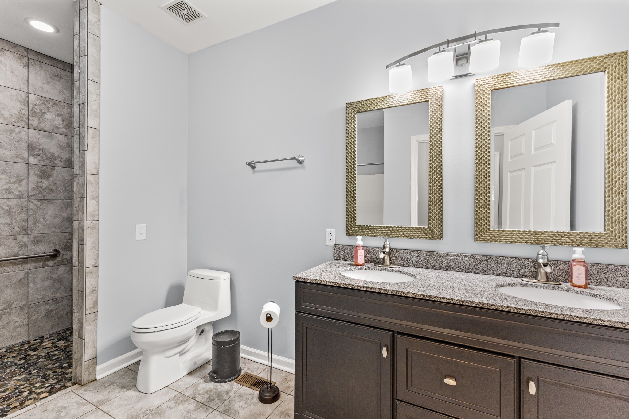1010 Jacob's Valley Road Joelton, TN 37080 - Photo 15 of 33 a bathroom with a granite countertop sink a toilet and a mirror