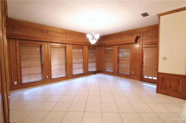 a view of a livingroom with an empty space and a window