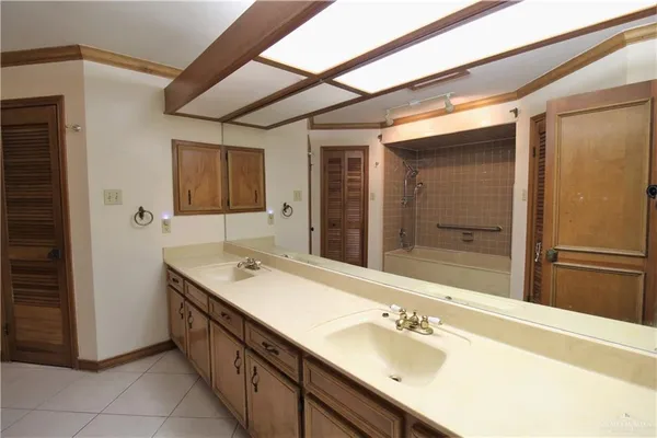 a bathroom with a sink double vanity and a mirror