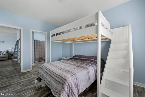 a bedroom with a bed and a view of closet