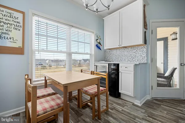 a view of a dining room with furniture and a window
