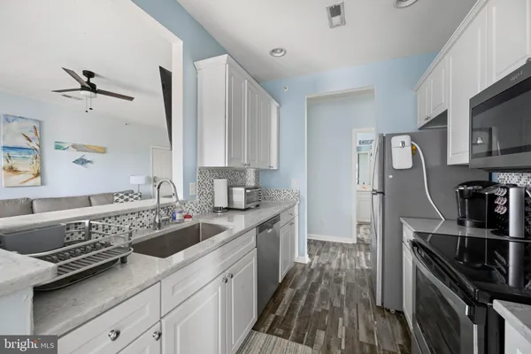 a kitchen with a sink stove and refrigerator