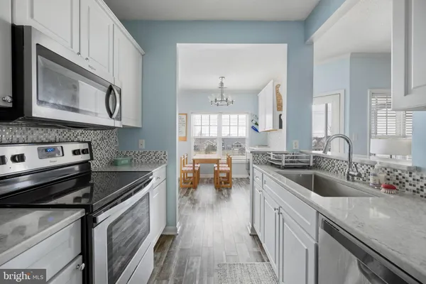 a kitchen with a stove microwave and sink