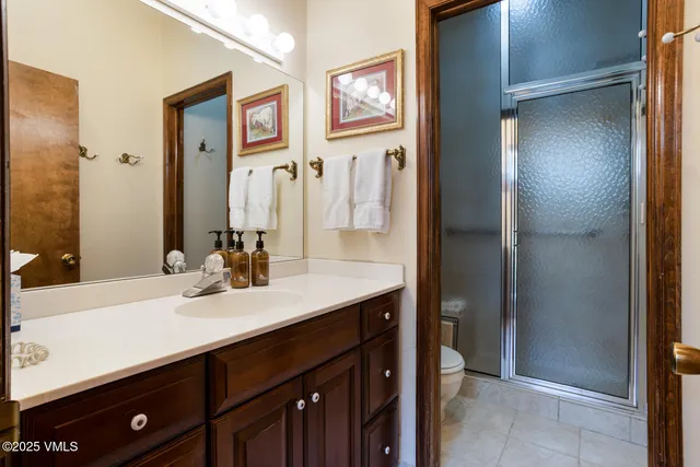 a bathroom with a sink a mirror and a shower
