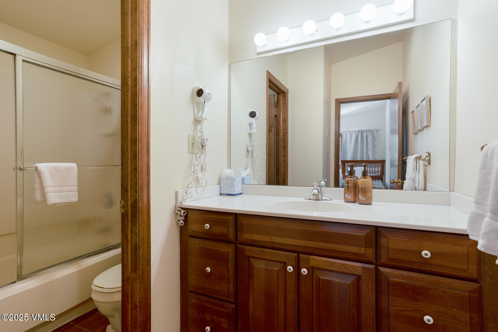 324 Beaver Dam Road, Unit B Vail, CO 81657 - Photo 13 of 22 a bathroom with a double vanity sink toilet and shower