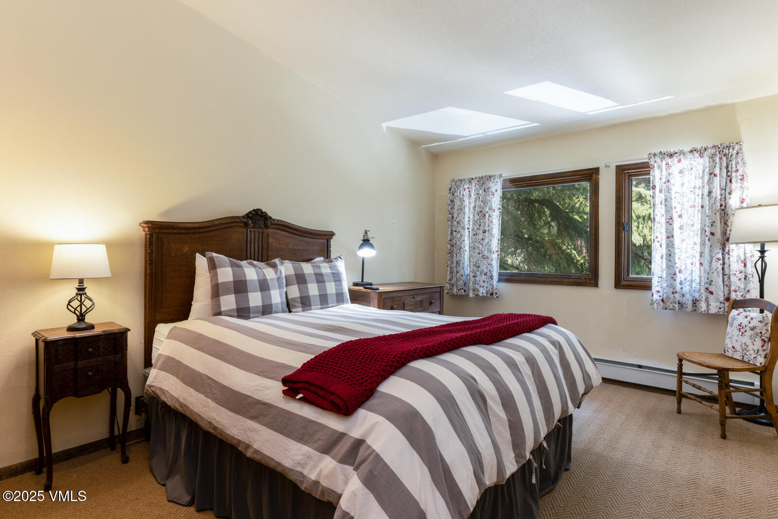 324 Beaver Dam Road, Unit B Vail, CO 81657 - Photo 16 of 22 a bedroom with a bed and wooden floor