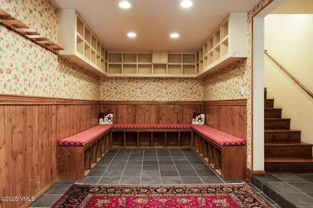 a hallway with a rug and stairs