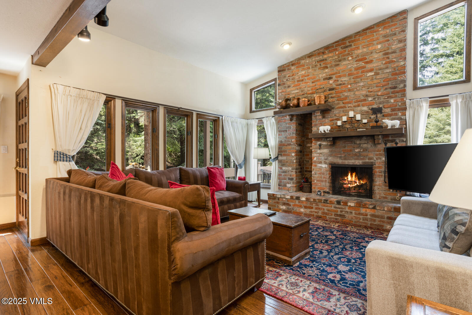 324 Beaver Dam Road, Unit B Vail, CO 81657 - Photo 3 of 22 a living room with furniture and a fireplace
