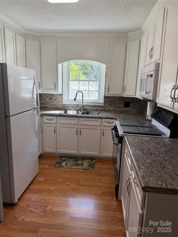 a kitchen with a sink stove and refrigerator