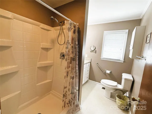 a bathroom with a shower a toilet and a shower