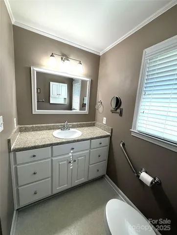 a spacious bathroom with a granite countertop sink mirror and bathtub