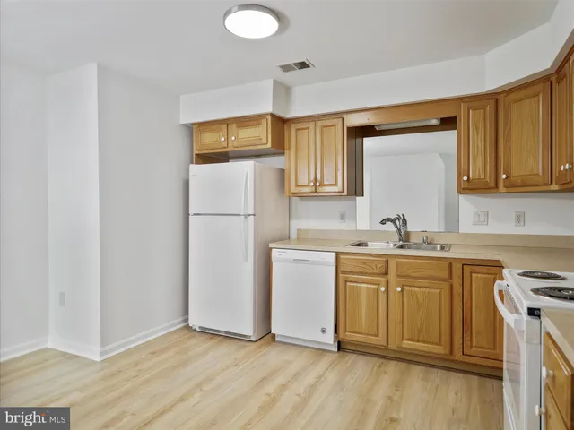 a kitchen with a refrigerator sink and stove