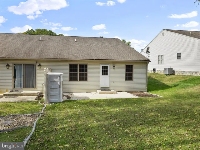 a backyard of a house with table and chairs