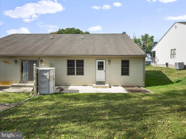 a backyard of a house with table and chairs