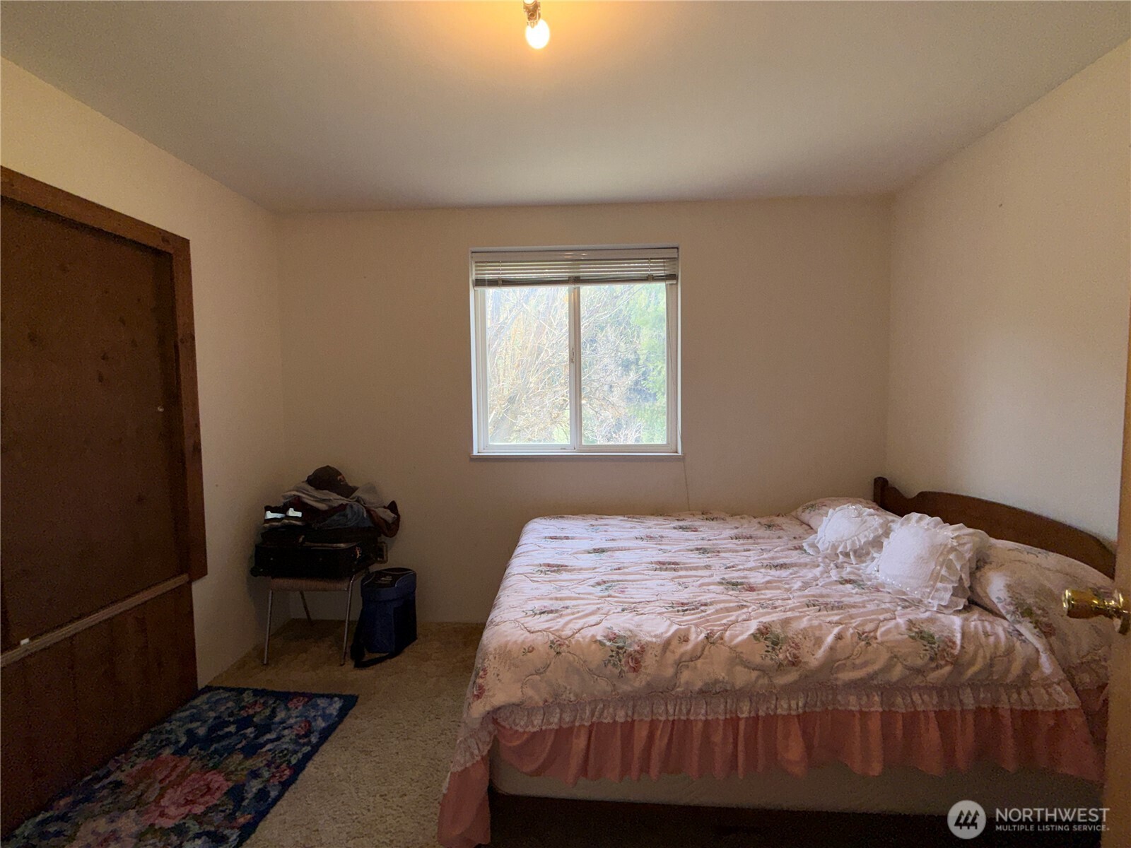 155 St Peters Creek Road Malo, WA 99150 - Photo 13 of 40 a bedroom with a bed and a window