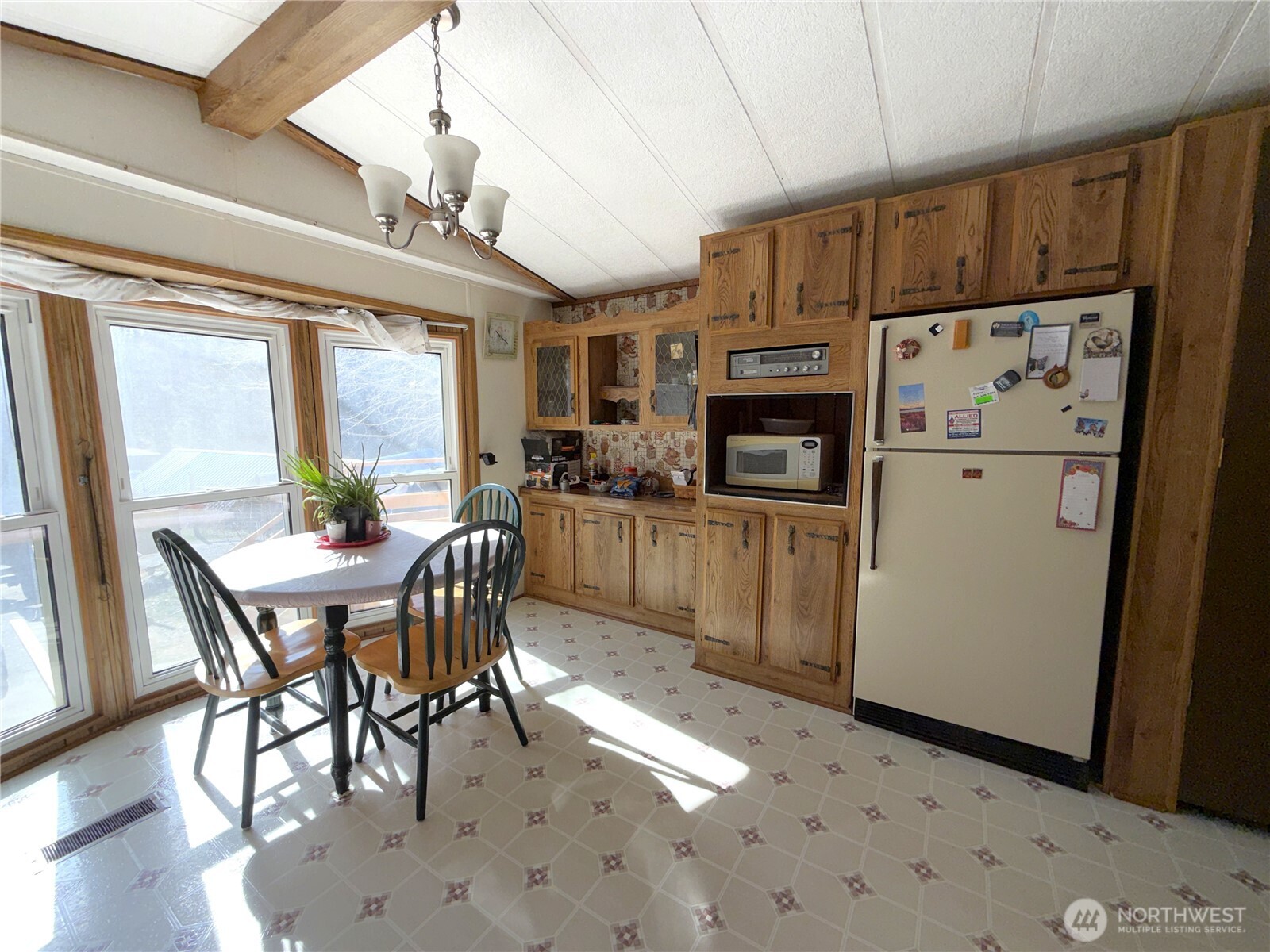155 St Peters Creek Road Malo, WA 99150 - Photo 6 of 40 a kitchen with stainless steel appliances kitchen island granite countertop a refrigerator a stove a sink a dining table and chairs with wooden floor