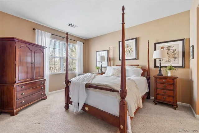 a bedroom with a bed closet and flat tv screen