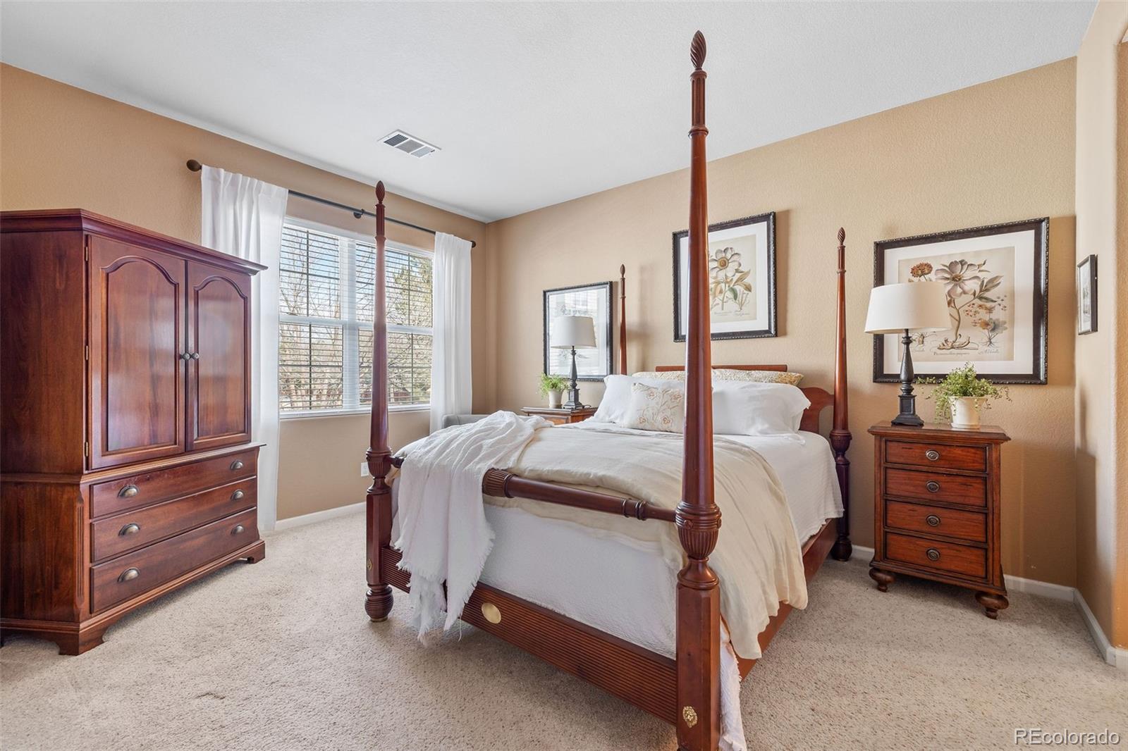 4035 South Dillon Way, Unit 204 Aurora, CO 80014 - Photo 14 of 24 a bedroom with a bed closet and flat tv screen