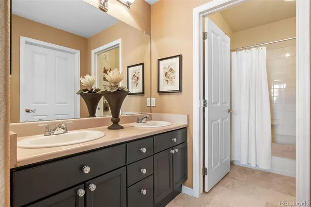 a bathroom with a double vanity sink mirror and